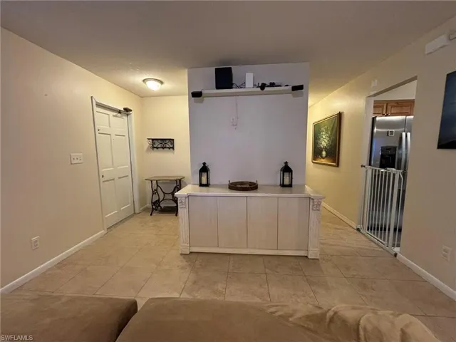 Living Area With Hall To primary Bedroom And Laundry Room And Garage
