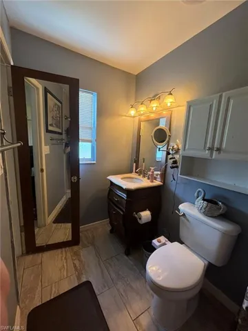 Bathroom with vanity, tile patterned flooring, and toilet
