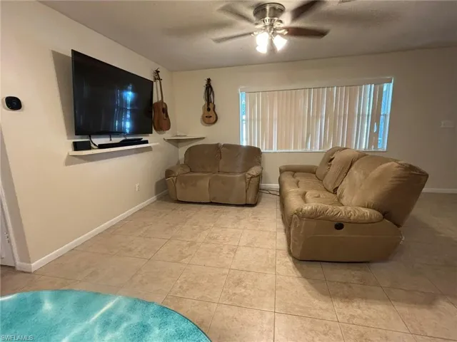 Living Room With Tile Floors and Ceiling Fan