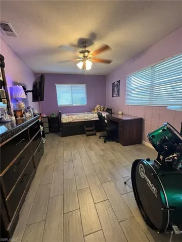 Guest Bedroom with tile floors and ceiling fan