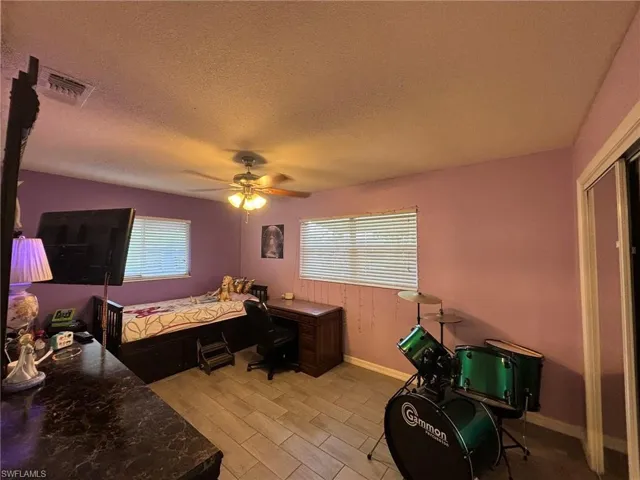 Guest Bedroom with tile floors and ceiling fan