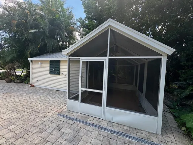 Back of property featuring a patio and a sunroom