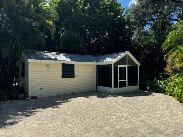 View of outbuilding featuring a sunroom