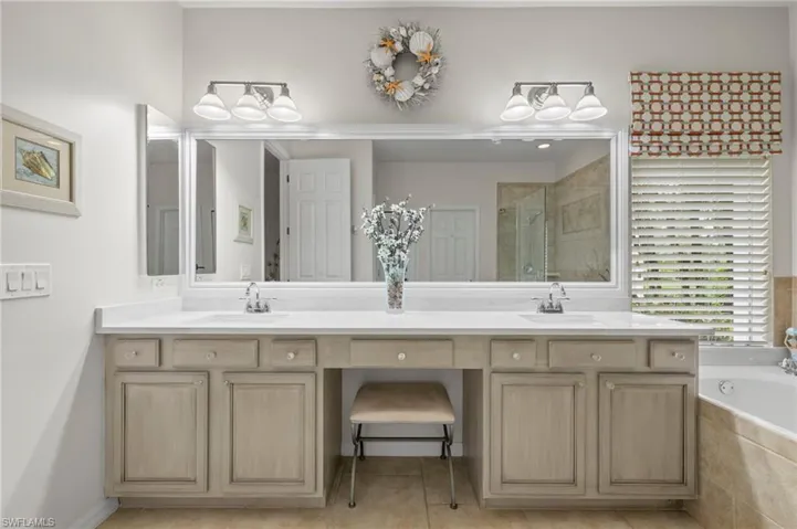 Bathroom with vanity, tile patterned floors, and separate shower and tub