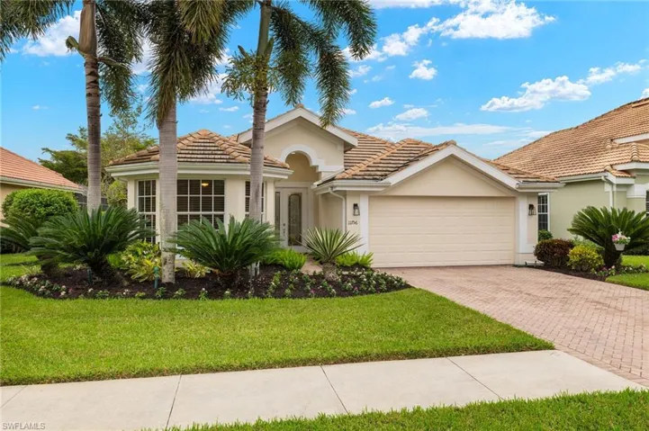 View of front of property with a garage and a front yard