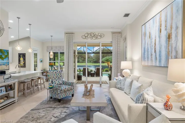 Tiled living room with sink and crown molding