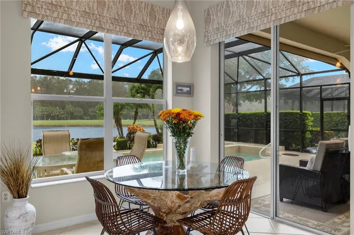 Sunroom featuring a water view