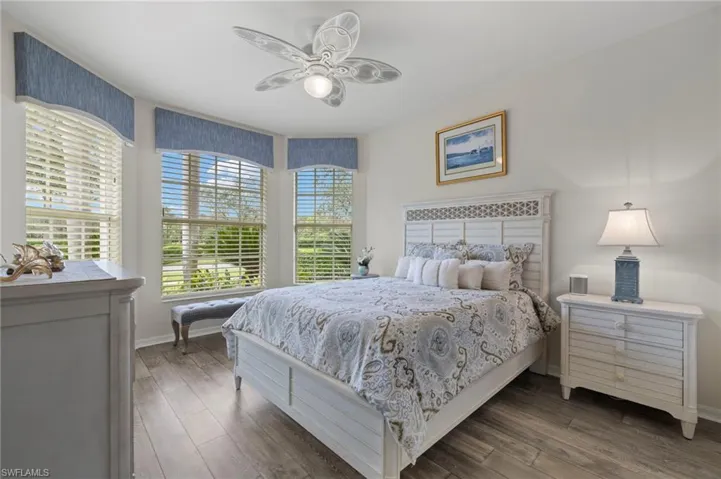 Bedroom featuring dark wood-type flooring and ceiling fan
