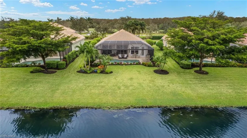 Birds eye view of property with a water view