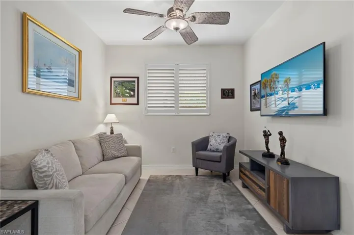 Living room featuring ceiling fan and light tile patterned floors