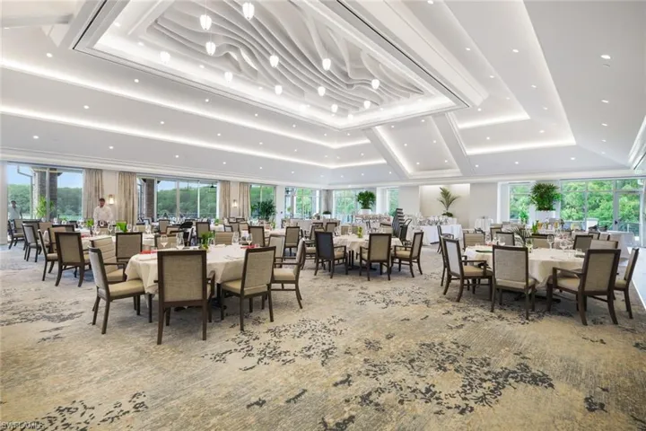 Carpeted dining room featuring a tray ceiling