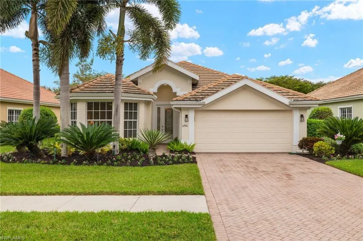 Mediterranean / spanish-style home with a front lawn and a garage