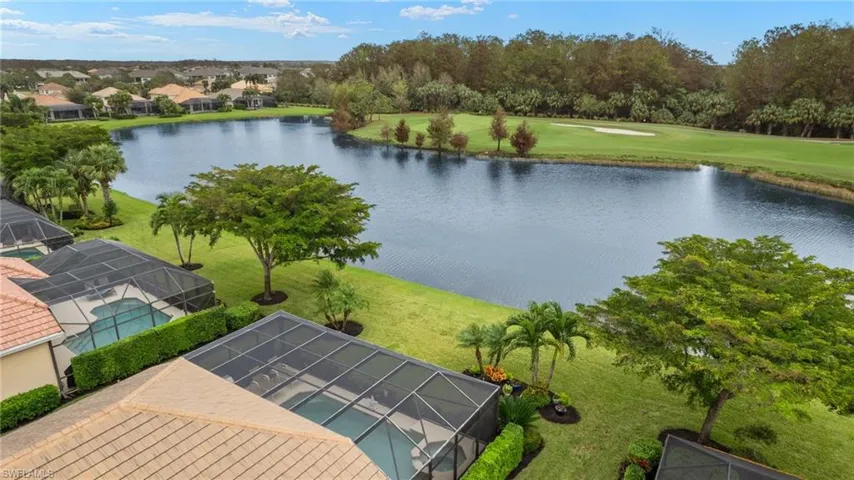 Birds eye view of property with a water view