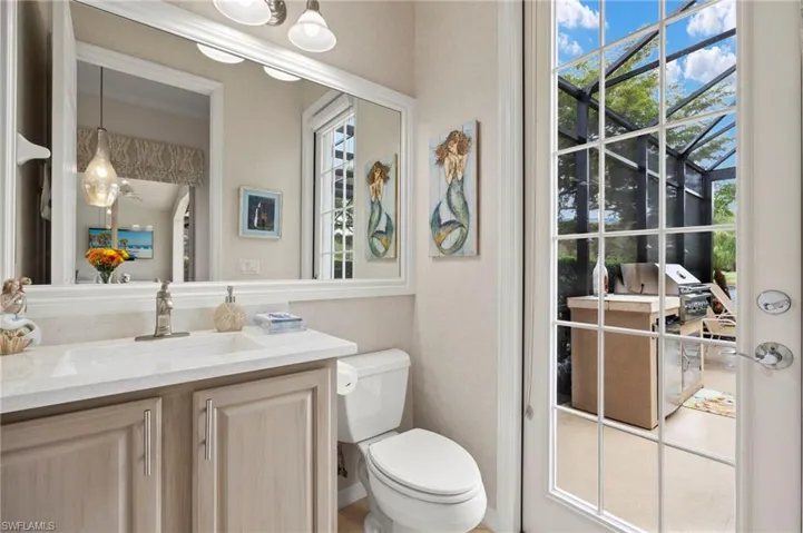 Bathroom with vanity, a healthy amount of sunlight, and toilet