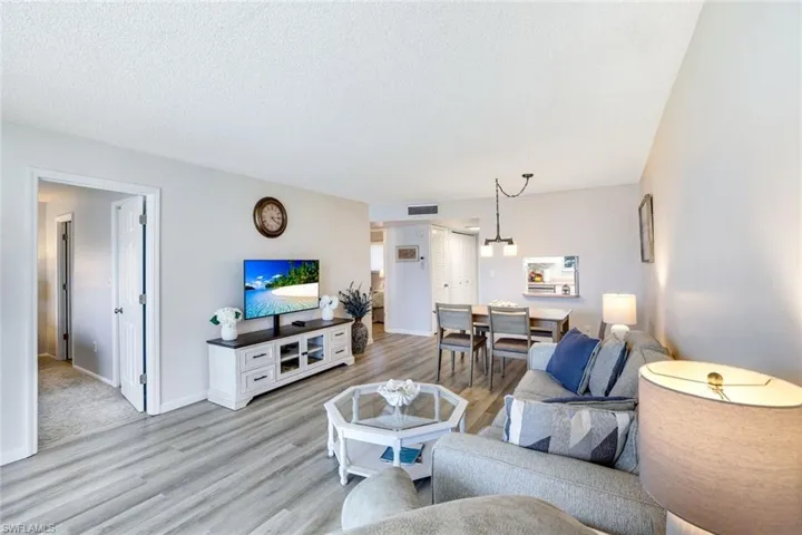 Living room featuring light wood-type flooring and a textured ceiling