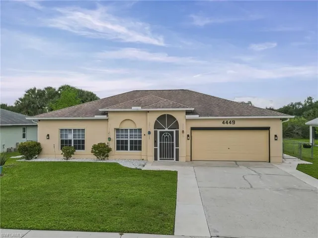 Single-story residence featuring a two-car garage, concrete driveway, and a covered entry