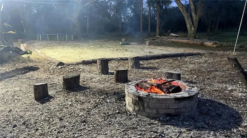 View of yard with a fire pit