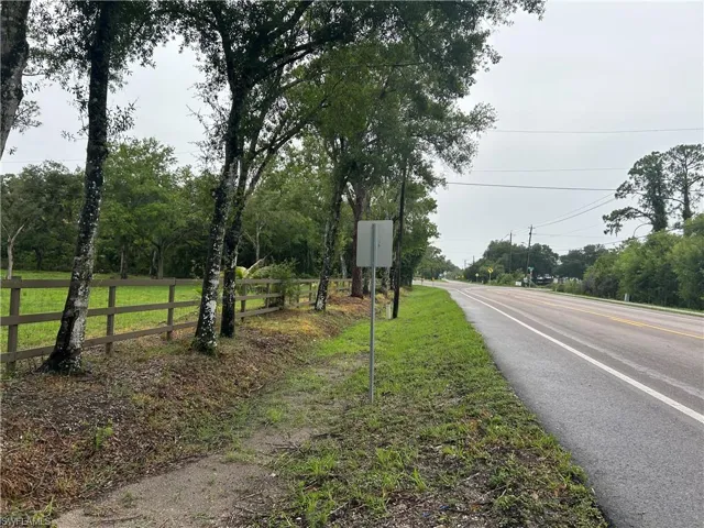 View of asphalt road featuring traffic signs