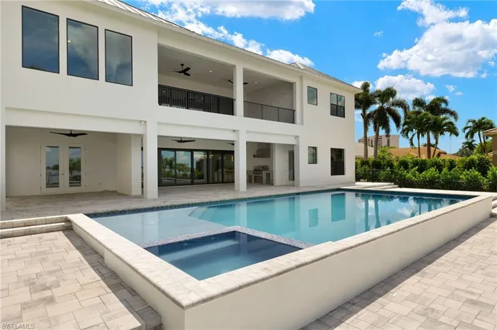 View of pool featuring a patio area, french doors, an in ground hot tub, and ceiling fan