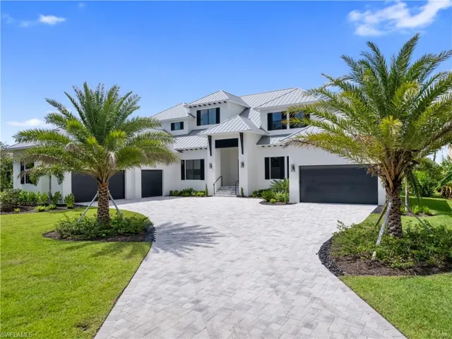 View of front of property with a front yard and a garage