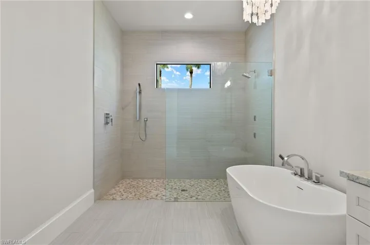 Bathroom featuring vanity, independent shower and bath, and tile patterned floors