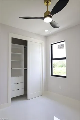 Unfurnished bedroom featuring a closet and a ceiling fan