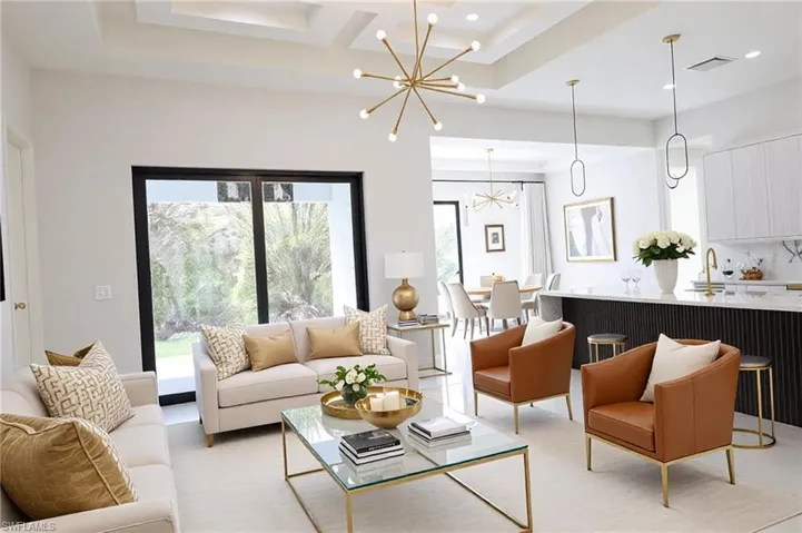 Living room featuring visible vents, recessed lighting, coffered ceiling, and an inviting chandelier