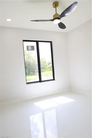 Tiled spare room with a ceiling fan, recessed lighting, and baseboards