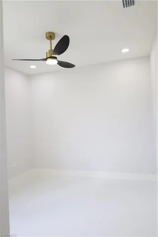 Spare room with visible vents, recessed lighting, baseboards, and ceiling fan