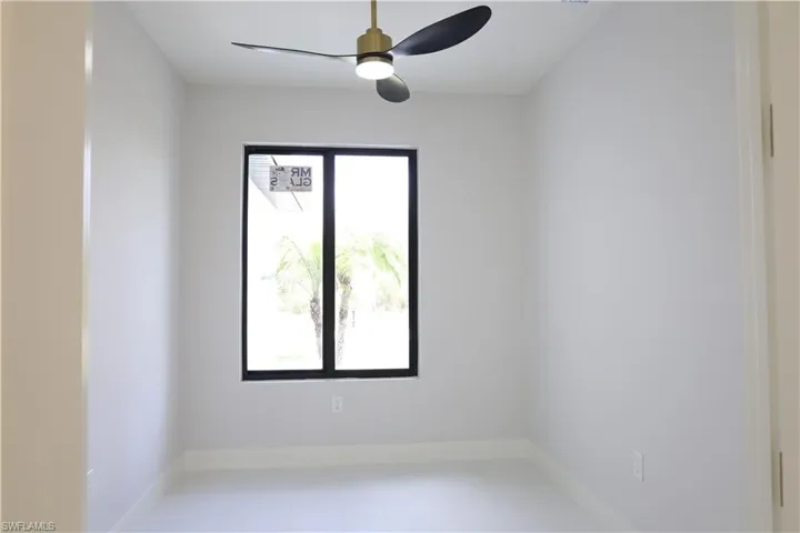 Spare room featuring baseboards and a ceiling fan