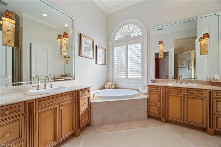 Full bath with ornamental molding, a sink, and tile patterned floors