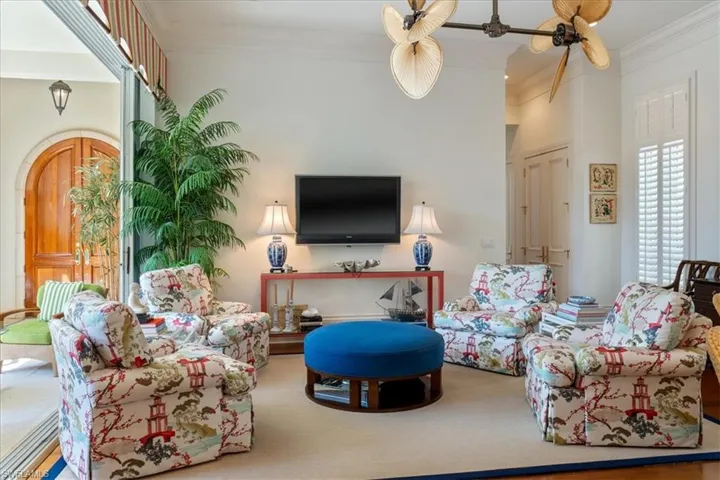 Carpeted living room featuring ornamental molding
