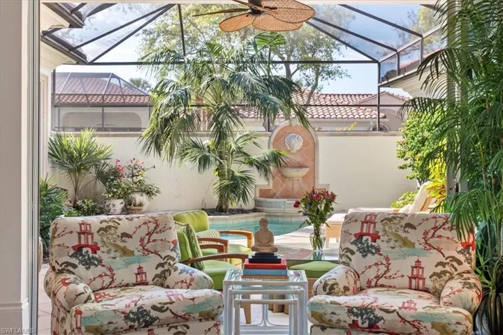 View of patio / terrace featuring a lanai, an outdoor pool, and a ceiling fan