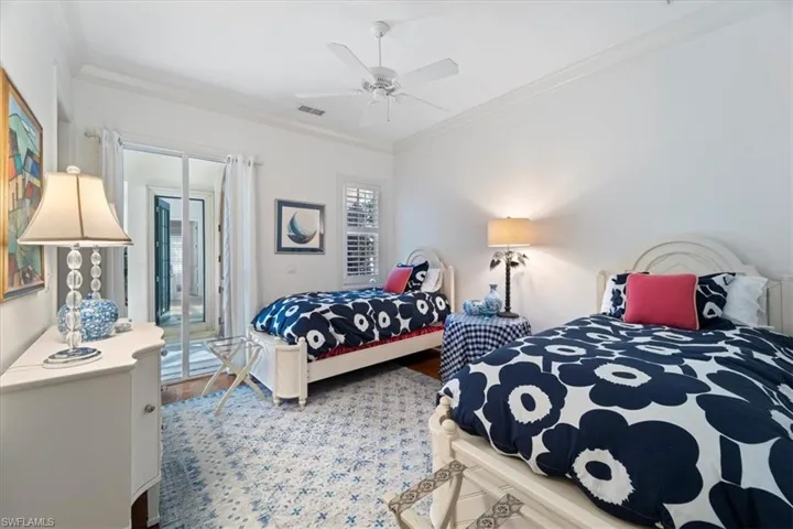 Bedroom featuring a ceiling fan, access to outside, ornamental molding, and wood finished floors