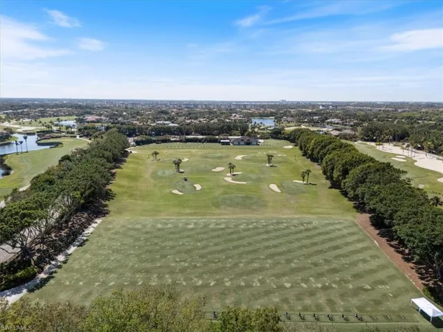Birds eye view of property featuring golf course view and a water view