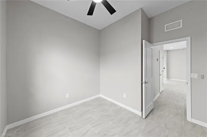 Spare room featuring baseboards and a ceiling fan
