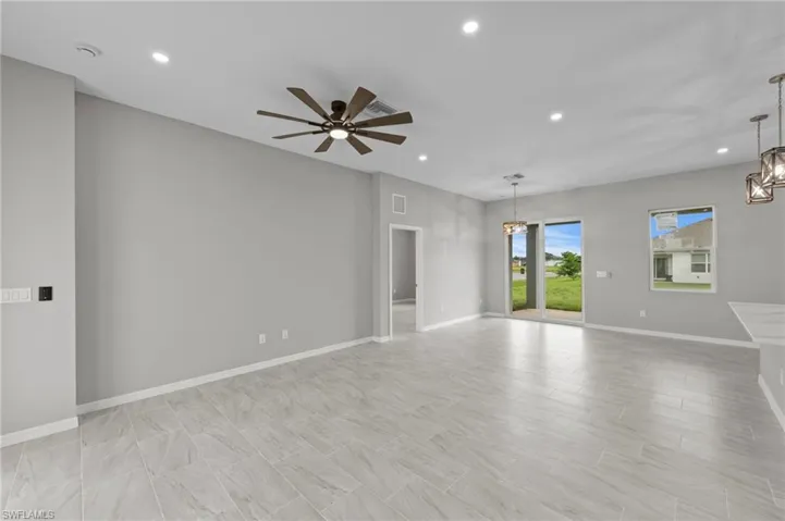 Spare room featuring recessed lighting, a chandelier, and a ceiling fan