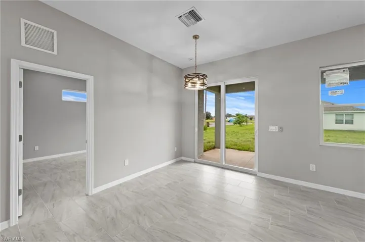 Unfurnished dining area featuring baseboards and a chandelier