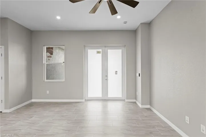 Empty room with french doors, a ceiling fan, and recessed lighting