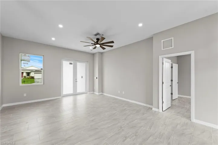 Spare room with recessed lighting, ceiling fan, and french doors
