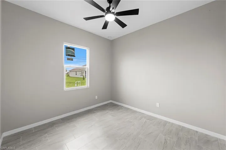 Empty room with baseboards and ceiling fan