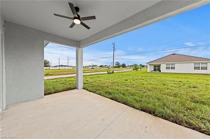 Covered porch with a lawn and a ceiling fan