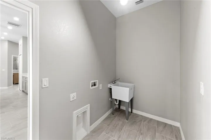 Washroom featuring hookup for a washing machine, recessed lighting, and hookup for an electric dryer
