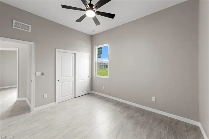 Unfurnished bedroom featuring ceiling fan and a closet