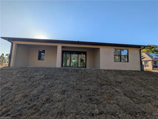 Rear view of property featuring stucco siding and a patio