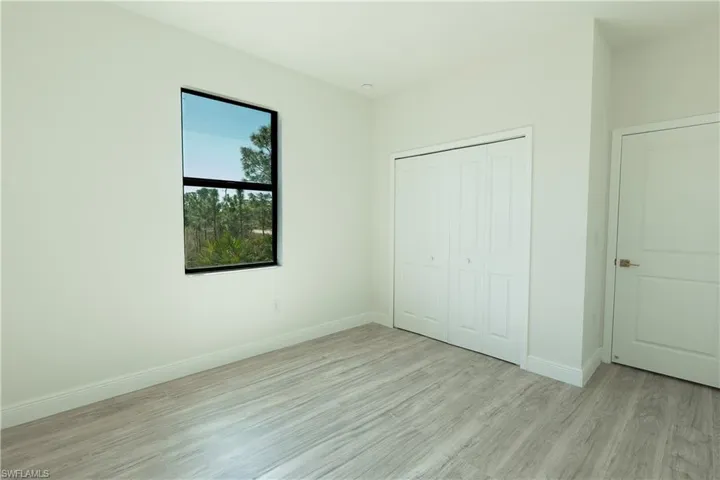 Unfurnished bedroom with light wood-style floors and a closet