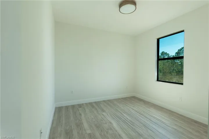 Empty room featuring light wood-type flooring and baseboards