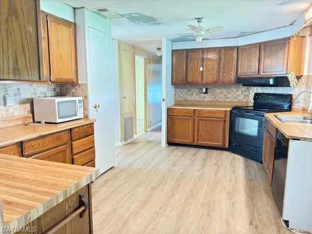 Large Kitchen featuring lots of wood cabinets