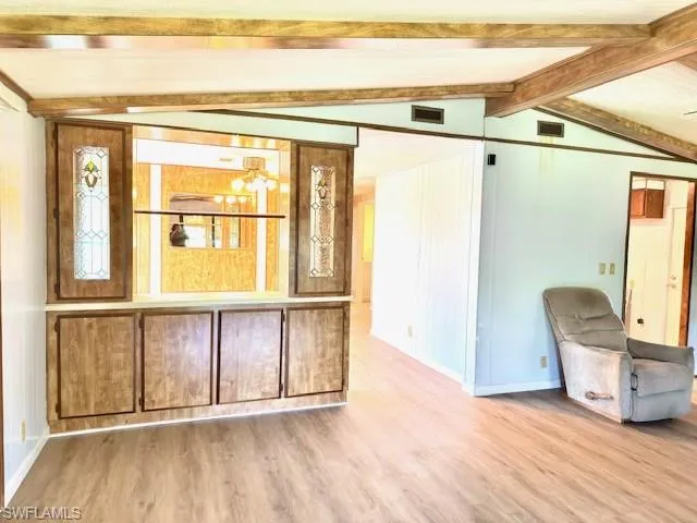 View into formal dining room with pass through cabinets