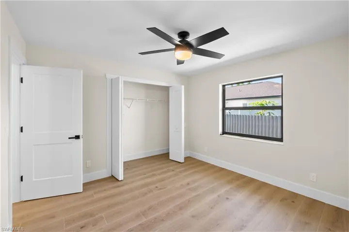 Unfurnished bedroom featuring ceiling fan and light hardwood / wood-style floors